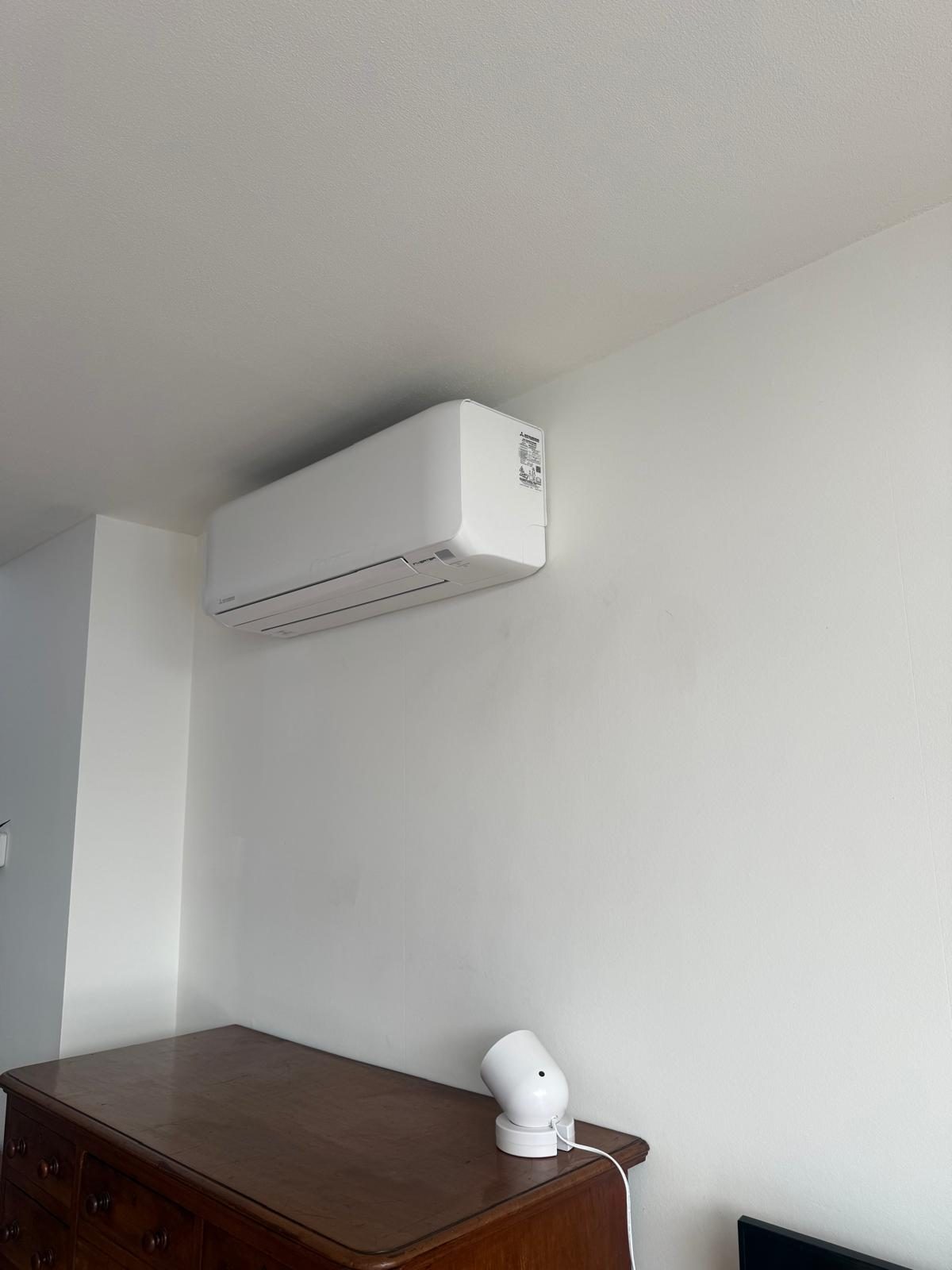 Airco-binnenunit in de hoek van een slaapkamer