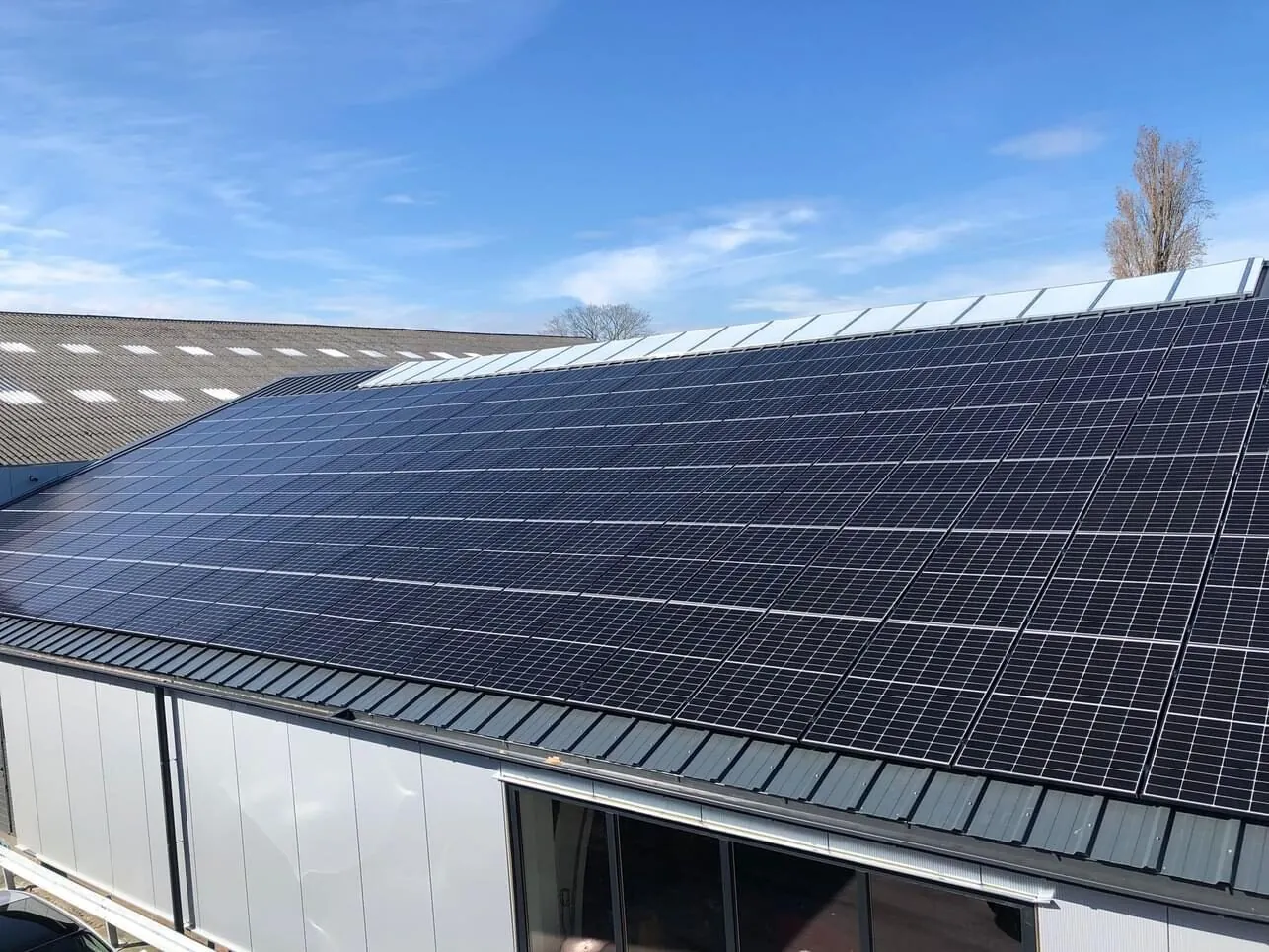 Grootschalige zonnepanelen-installatie op een bedrijfsloods